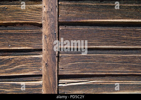Weathered wood plank siding background texture with natural brown color tones Stock Photo