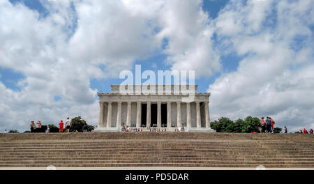 Dwarfed by blue skies and white summer clouds, the Lincoln Memorial sits atop its plateau of steps in Washington, DC. Stock Photo