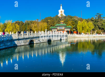 Yongan Bridge Buddhist White Stupa Dagoba Gate Jade Flower Island Beijing China Beihai public park created  1000AD. Stupa built in 1600s. Stock Photo