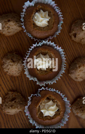 Mums homemade carrot cupcakes with cream cheese filling. Stock Photo
