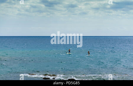 Stand Up Paddling in the blue sea Stock Photo