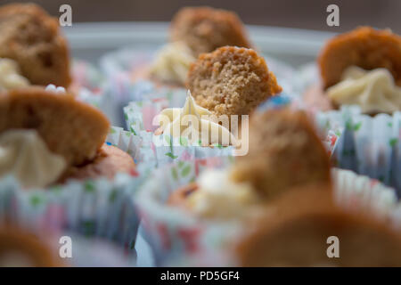 Mums homemade carrot cupcakes with cream cheese filling. Stock Photo