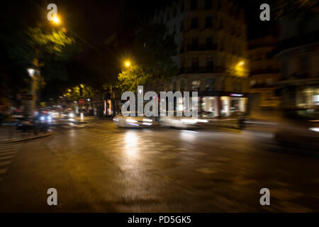 Blurry motion image of cars in traffic at night in Paris. Stock Photo