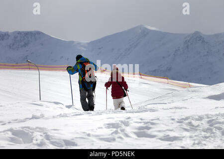 Father and daughter on ski resort after snowfall in sun day. Caucasus Mountains, Georgia, region Gudauri at winter. Stock Photo