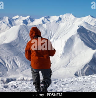 Skier makes photo on top of high snowy mountain. Caucasus Mountains in winter, Georgia, region Gudauri. Stock Photo