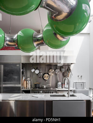 Stainless steel kitchen units in contemporary kitchen with green light designed by Andy Martin Stock Photo