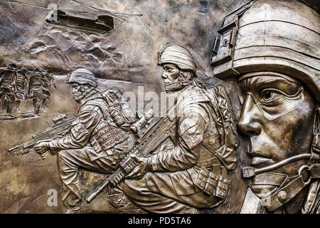 Bronze sculpture war scene by sculptor Paul Day, London, UK. Part of the Iraq and Afghanistan War Memorial, plaque, depicting British Army in action. Stock Photo