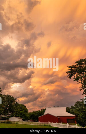 Stormy evening over a farm in Ames, Iowa, with pink clouds. Stock Photo