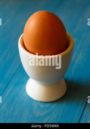 Boiled egg in a white egg cup Stock Photo