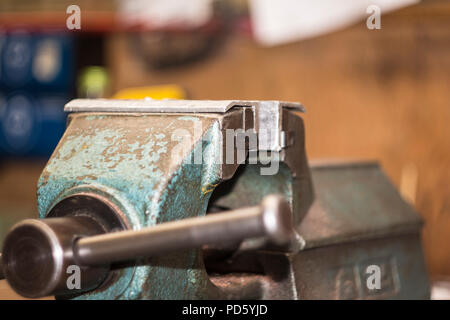 Vice on a workbench in a metal and wood working workshop Stock Photo