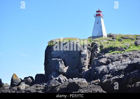 Red and white lighthouse on the edge of a cliff (Boar's Head Lighthouse, Nova Scotia) Stock Photo