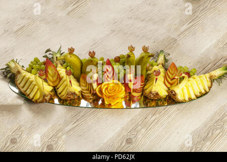 Very nice and artistically sliced fruits on a platter. Stock Photo