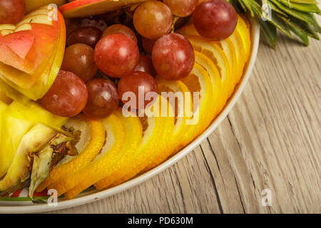 Very nice and artistically sliced fruits on a platter. Stock Photo