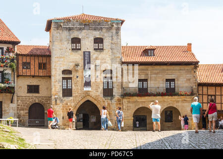 Santillana, Spain - 8th July 2018: Tourists taking photos of Posada La Casa del Organista. The building is an inn. Stock Photo