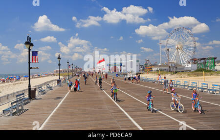 People walking and biking along the boardwalk in Ocean City, New Jersey, USA Stock Photo