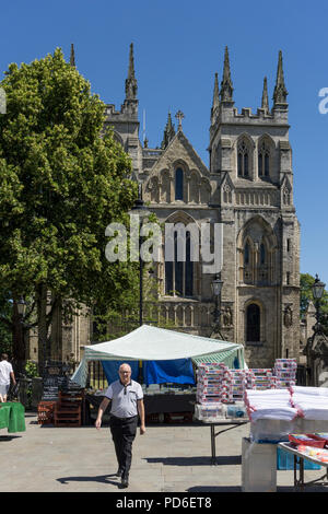 Market Day in Summer, Selby, North Yorkshire, UK; with the Medieval Selby Abbey in the background. Stock Photo