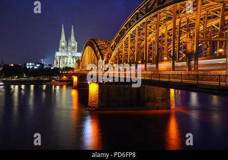 Night panorama of Cologne, Germany, with the river Rhine, the railway Hohenzollern Bridge and Cologne Cathedral
