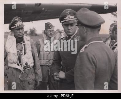 Image from the photo album of Oberleutnant Oscar Müller of  Kampfgeschwader 1: Oberleutnant Friedrich Clodius (left) in conversation with Chief Runge of his ground crew. Clodius was the Staffelkapitän of 5./KG 1 during the summer of 1941 and until he was posted missing on 8th November 1941. Stock Photo