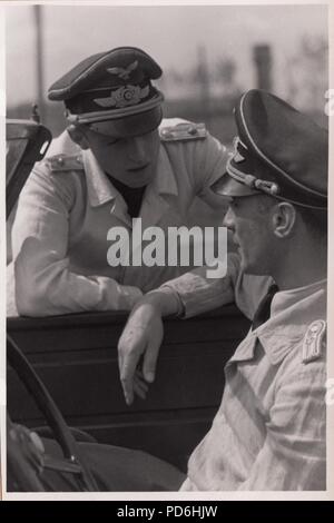 Image from the photo album of Oberleutnant Oscar Müller of  Kampfgeschwader 1: Oberleutnants Oscar Müller and Siegfried Freiherr von Cramm of Kampfgeschwader 1 in discussion, during the summer of 1942. Stock Photo