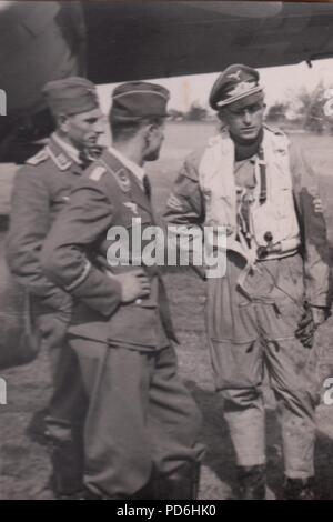 Image from the photo album of Oberleutnant Oscar Müller of  Kampfgeschwader 1: Oberleutnant Friedrich Clodius (left) is greeted by Leutnant Oscar Müller on landing. Clodius was the Staffelkapitän of 5./KG 1 during the summer of 1941 and until he was posted missing on 8th November 1941. Stock Photo