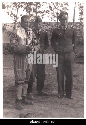 Image from the photo album of Oberleutnant Oscar Müller of  Kampfgeschwader 1: Oberleutnant Friedrich Clodius (left) and Leutnant Oscar Müller (centre), summer 1941. Clodius was the Staffelkapitän of 5./KG 1 during the summer of 1941 and until he was posted missing on 8th November 1941. Stock Photo