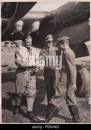 Image from the photo album of Oberleutnant Oscar Müller of  Kampfgeschwader 1: Oberleutnant Friedrich Clodius (left) is greeted by Leutnant Oscar Müller on landing. Clodius was the Staffelkapitän of 5./KG 1 during the summer of 1941 and until he was posted missing on 8th November 1941. Stock Photo