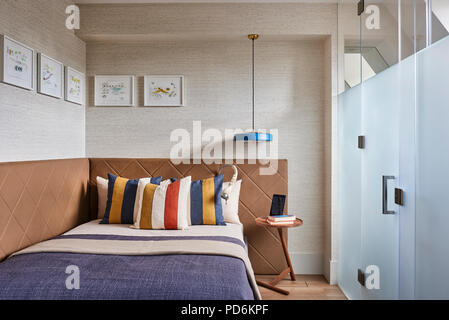 Striped pillows on double bed with frosted glass Stock Photo