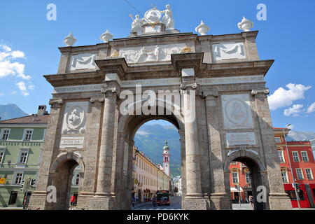 INNSBRUCK, AUSTRIA - JULY 2, 2018: Triumphal Arch located on street Maria Theresien Strasse, with the bell tower of Servite Monastery in background Stock Photo