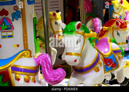 Merry-go-round colorful carousel horses for little baby kids. Stock Photo