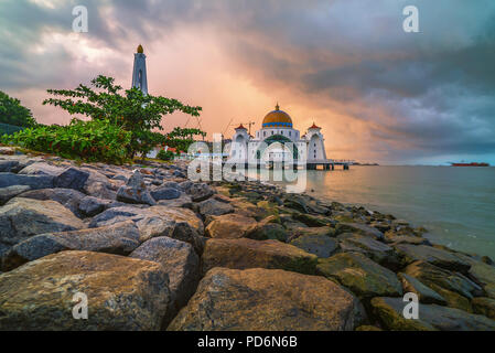 Beautiful sunrise over the majestic mosque, Malacca Straits Floating Mosque (Masjid Selat Melaka). Stock Photo