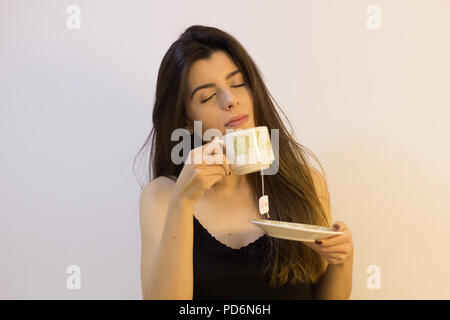 Beautiful and elegant woman drinking tea. Stock Photo