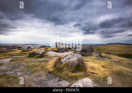 Idyllic landscape of Peak District,Derbyshire,Uk.View from top of the hill with large boulders on scenic mountain valley and dramatic sky over land. Stock Photo