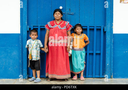 A ngobe woman dressing the traditional costumes and its children. Stock Photo