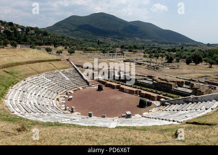 View of the ancient theatre which has the cavea is carved into the hillside and dates from around the 3rd century BC. Ancient Messene. Peloponnese. Gr Stock Photo