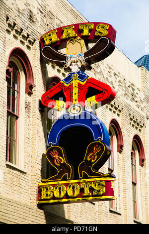 One of the many neon signs in Nashville, Tennessee's Broadway district - this one for a hat and boot shop. Stock Photo