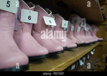 Rows of pink cowgirl boots for girls for sale in a boot shop in Nashville, TN, USA Stock Photo