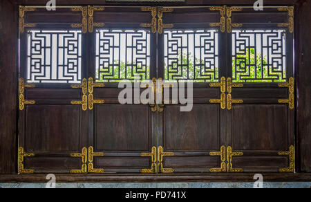 four doors connected made of wood with brass or gold colored hardware. Stock Photo