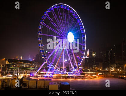 HONG KONG -APR 2, 2016: Ferris Wheel in Hong Kong at night on Apr 2, 2016. The Hong Kong Observation Wheel is located in Central, Hong Kong. Stock Photo