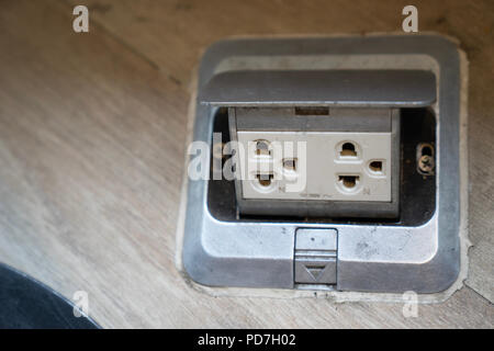 build in double plug socket or electrical power socket on wood background. Stock Photo