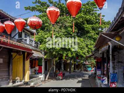 A look down a street with orange hanging lanterns in Ancient Town Hoi An, Vietnam. Stock Photo