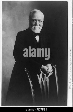 Andrew Carnegie, three-quarter length portrait, standing behind chair, facing front Stock Photo