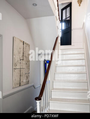 Wooden staircase painted in mid French Grey whilst the walls are Slaked Lime from Little Greene. Stock Photo