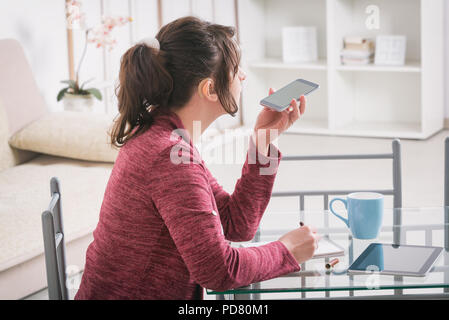 Hearing impaired woman working with tablet at home or office Stock Photo