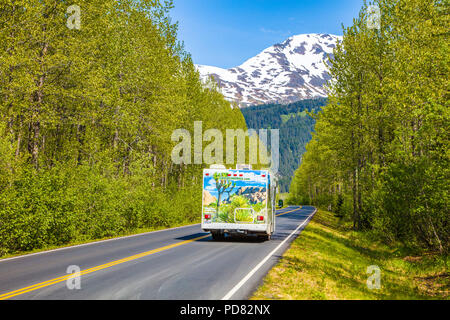RV on Herman Leirer Road, commonly called 'Exit Glacier Road with snow capped mountain in distance in Seward Alaska Stock Photo