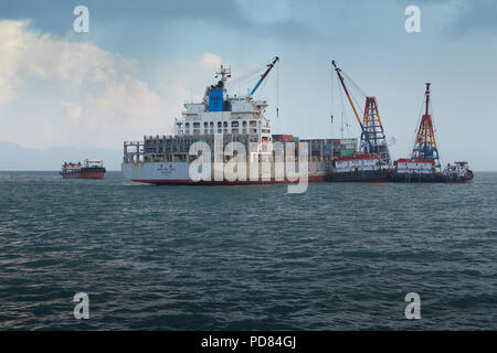 WAN HAI LINES Container Ship, WAN HAI 303, Unloading Shipping Containers In A Mid-Stream Operation, Off Victoria Harbour, Hong Kong. Stock Photo