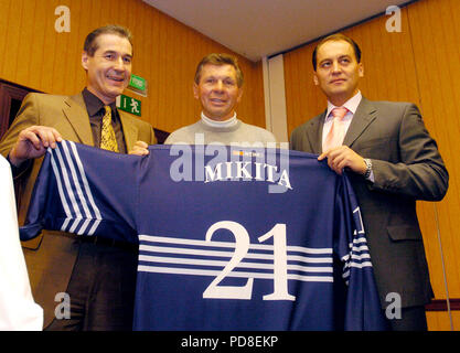 Bratislava, Slovakia. 02nd Dec, 2004. ***FILE PHOTO*** Stan Mikita (center), legendary Slovak-born Canadian former ice hockey player for the Chicago Black Hawks of NHL poses with World Stars Team dress during a press conference in Bratislava, Slovakia, on December 2, 2004. On the photo are seen also organizers of hockey beneficial Martin Bezak (left) and Maros Krajci (right). Credit: Samuel Kubani/CTK Photo/Alamy Live News Stock Photo