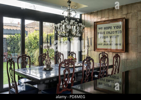 Lead crystal Baccarat chandelier above dining table in London home Stock Photo