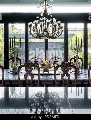 Lead crystal Baccarat chandelier above dining table in London home Stock Photo