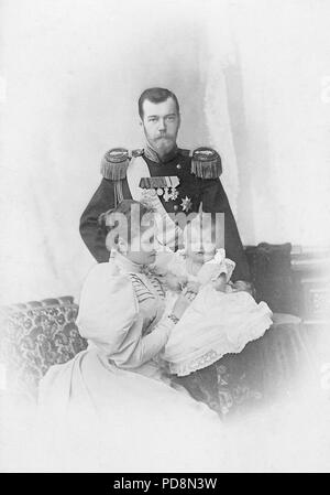 Tsar Nicholas II of Russia. 1868-1918. The last emperor of Russia. Pictured here with his wife Empress Alexandra and their firstborn child Olga ca. 1896 Stock Photo