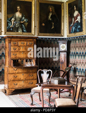 Framed artwork with table, chairs and writing bureau Stock Photo